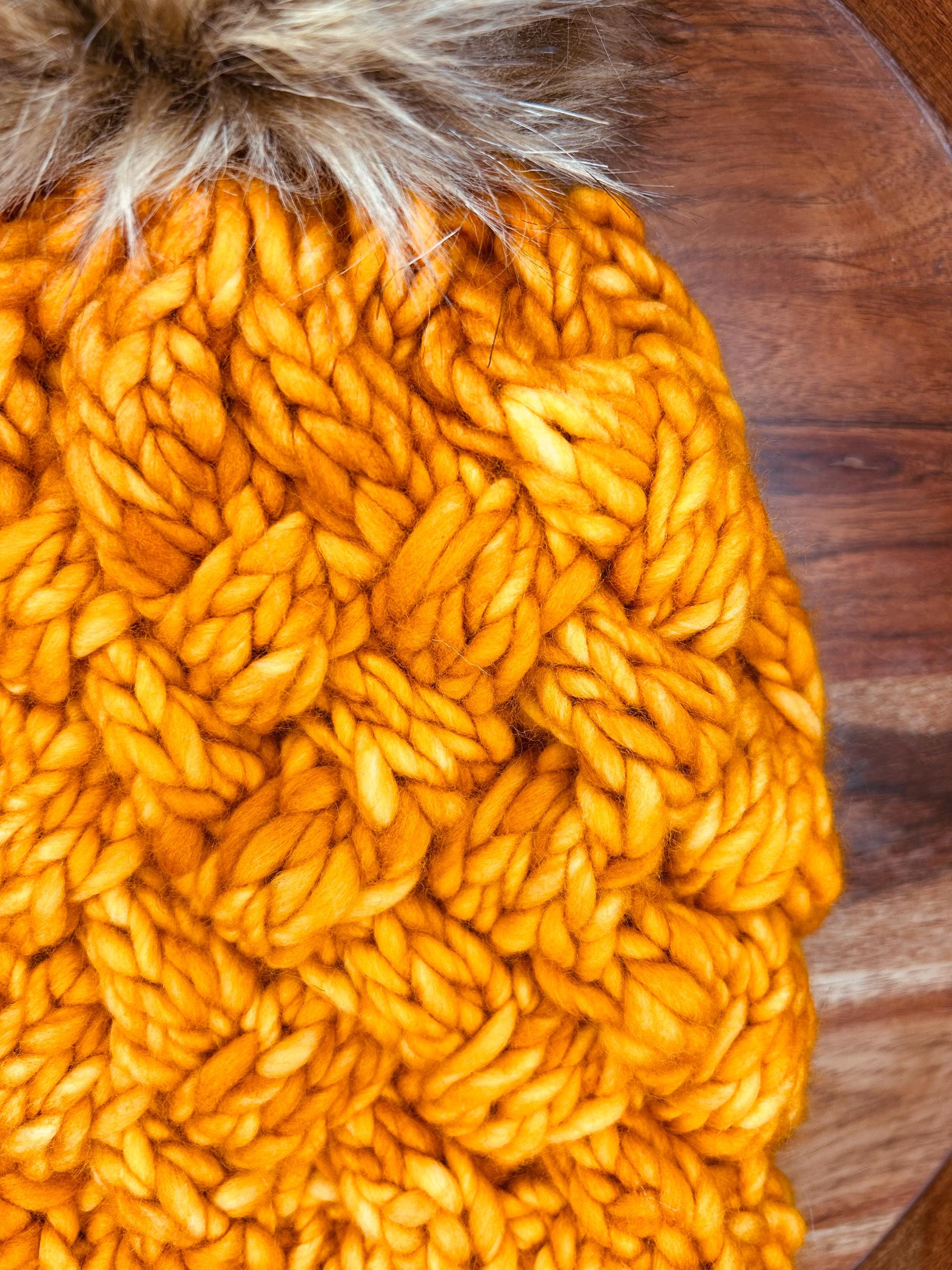 Handmade Merino Wool Knit Beanie: orange colour cable knit with Faux Fur Pompom